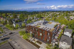 Seattle apartment for rent - an aerial view of a building in a city with trees