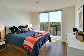 Seattle apartment for rent - a bedroom with a bed and a sliding glass door