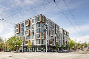 Seattle apartment for rent - A modern multi-story building with a mix of brown and white exterior.