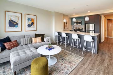 Seattle apartment for rent - a living room and kitchen with a couch and a table