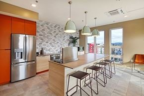 Seattle apartment for rent - a kitchen with a large island and a stainless steel refrigerator