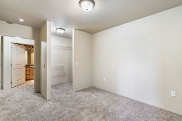 Seattle apartment for rent - a spacious living room with carpet and a door to a bathroom