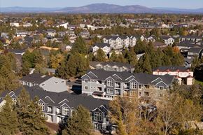 Bend apartment for rent - A large group of houses are surrounded by trees.