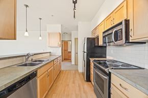 Seattle apartment for rent - a kitchen with stainless steel appliances and wooden cabinets