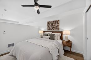 Seattle apartment for rent - A bedroom with a large bed and a ceiling fan.