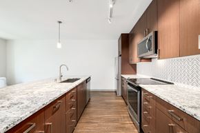 Seattle apartment for rent - a large kitchen with marble counter tops and wooden cabinets