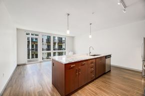 Seattle apartment for rent - a large kitchen with wood floors and a large island in the middle