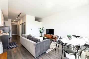 Seattle apartment for rent - a living room with a couch and a table with chairs