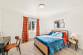 Lynnwood apartment for rent - a bedroom with a bed and a desk and a window