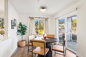Lynnwood apartment for rent - a dining room with a table and chairs and a balcony