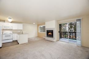 Everett apartment for rent - A living room with a fireplace and sliding glass doors.