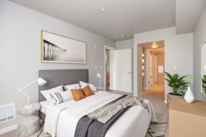 Seattle apartment for rent - a bedroom with a bed and a view of a hallway