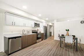 Seattle apartment for rent - A modern kitchen with a dining table set for two.