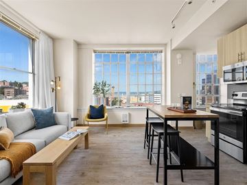 Tacoma apartment for rent - a living room with a couch and a table in front of a window