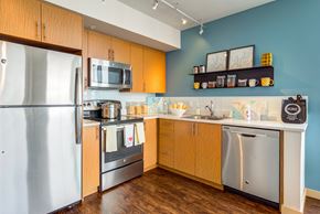 Seattle apartment for rent - a kitchen with wood cabinets and stainless steel appliances