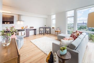 Seattle apartment for rent - a living room with a couch and a table in front of a window