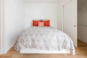 Seattle apartment for rent - a bedroom with a bed and white walls
