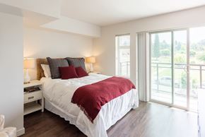 Kirkland apartment for rent - a bedroom with a bed and a sliding glass door