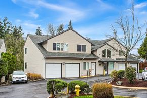 Burien apartment for rent - A house with a white car parked in front.
