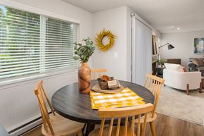 Kent apartment for rent - a dining room with a table and chairs and a large window