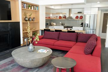 Seattle apartment for rent - a living room with a red couch and a coffee table