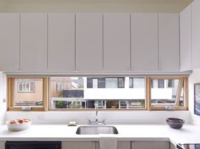 Portland apartment for rent - a kitchen with white cabinets and a sink and a window