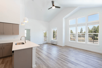 Bend apartment for rent - A spacious kitchen with a white countertop and wooden flooring.