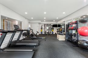 Wilsonville apartment for rent - A gym with treadmills, weights, and exercise equipment.