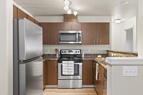 Hillsboro apartment for rent - A modern kitchen with a stainless steel refrigerator and a stove top oven.