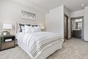 Lacey apartment for rent - A bedroom with a large bed and a painting on the wall.
