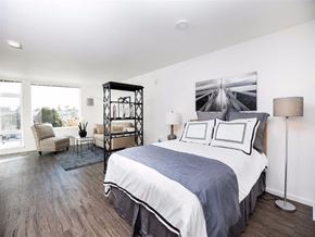 Seattle apartment for rent - A bedroom with a large bed and a chair.