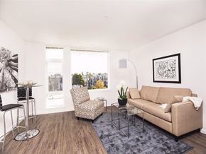 Seattle apartment for rent - A living room with a couch, chair, and table.