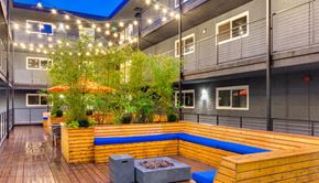 Seattle apartment for rent - a large patio with a wooden deck and a blue pool
