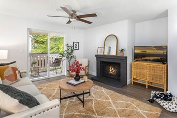 Burien apartment for rent - A living room with a fireplace and a painting on the wall.