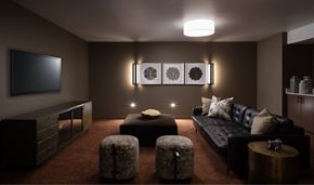 Seattle apartment for rent - A modern living room with a black couch, a television, and a coffee table.