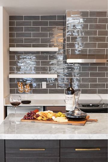 Seattle apartment for rent - A kitchen counter with a wine bottle, glass, and a plate of food.