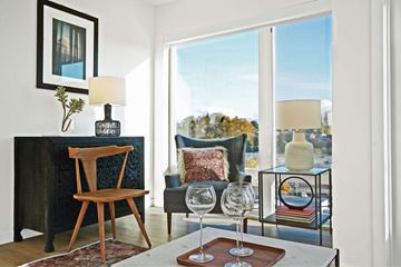 Seattle apartment for rent - A living room with a wooden chair and a glass table.