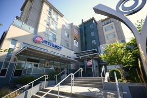 Seattle apartment for rent - A gym named 24 Hour Fitness is located in a modern building.