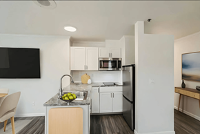 Seattle apartment for rent - a kitchen with white cabinets and a stainless steel refrigerator