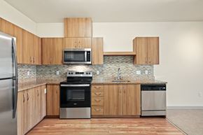 Seattle apartment for rent - a kitchen with wooden cabinets and stainless steel appliances