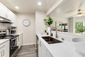 Renton apartment for rent - a kitchen with white cabinets and a large white sink