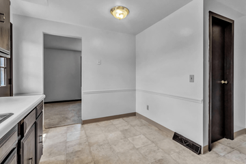 Amherst triplex for rent - A kitchen with a white counter top and a black door.