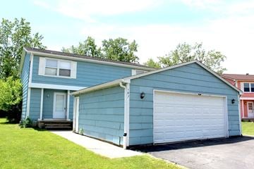 Amherst triplex for rent - A blue house with a white garage door.