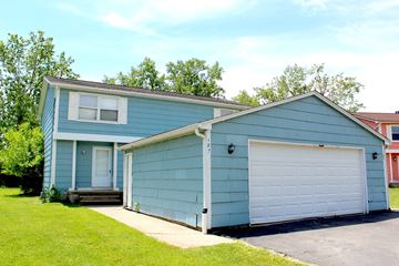 Amherst triplex for rent - A blue house with a white garage door.