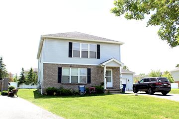 Amherst triplex for rent - A house with a blue car parked in front.