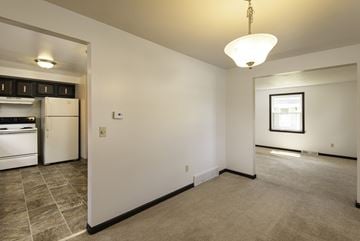 Amherst triplex for rent - A kitchen with white appliances and a small framed picture on the wall.