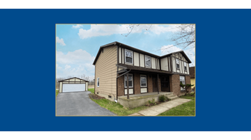 Amherst triplex for rent - A two-story house with a garage on the left side.