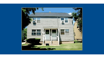 Buffalo triplex for rent - A two-story house with a front porch and a white door.