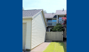 Amherst townhouse for rent - A house with a grey roof and a white siding wall.