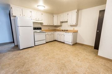 Amherst triplex for rent - A kitchen with white appliances and cabinets.